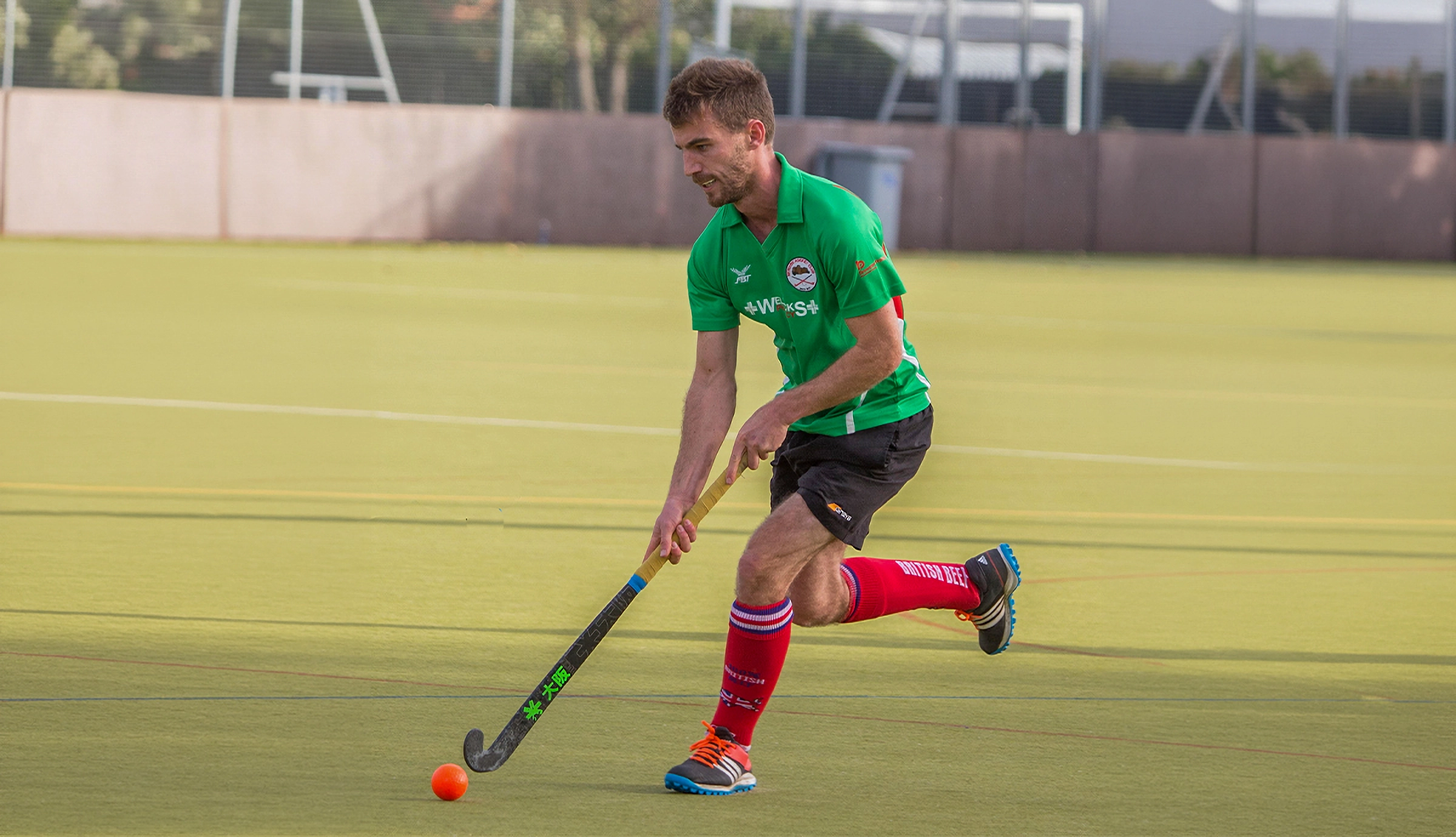 Man playing hockey and running with ball